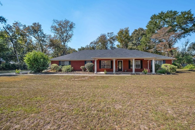 ranch-style house featuring a porch and a front yard