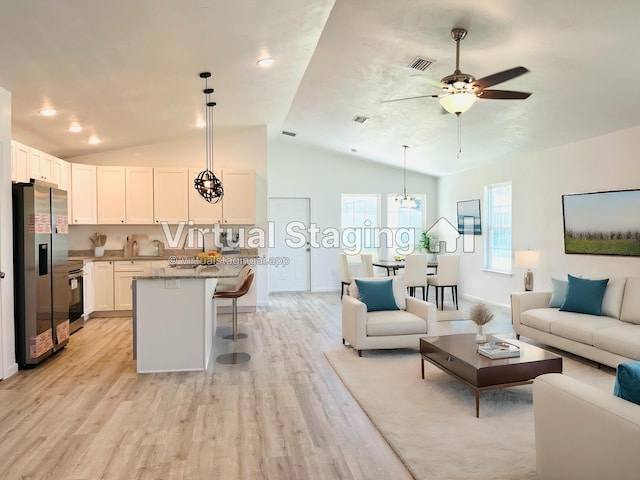 living area with lofted ceiling, visible vents, light wood-style floors, baseboards, and ceiling fan with notable chandelier