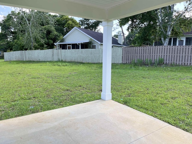 view of yard featuring fence and a patio area