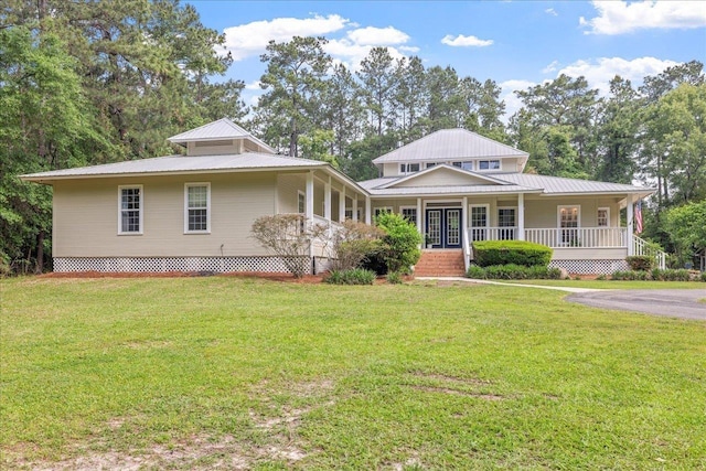 1445 Silver Pine Ln, Tallahassee, FL 32312 - farmhouse inspired home featuring covered porch, metal roof, and a front lawn