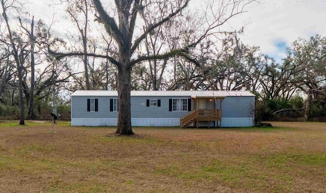 back of property with a lawn