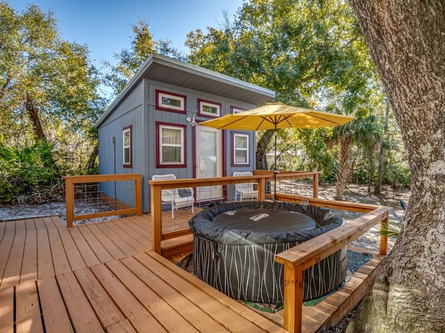 wooden deck with a jacuzzi