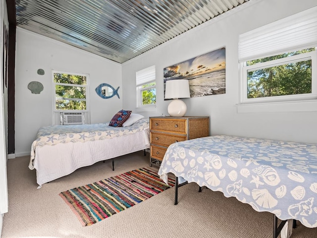 carpeted bedroom with vaulted ceiling, multiple windows, and cooling unit