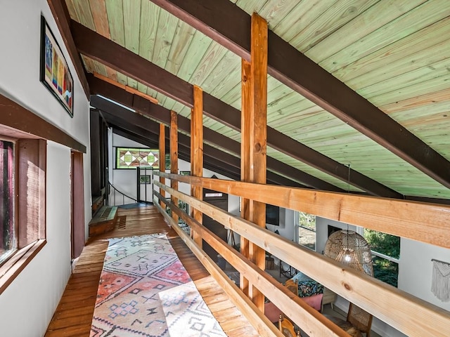 corridor with wood ceiling, vaulted ceiling with beams, and wood-type flooring