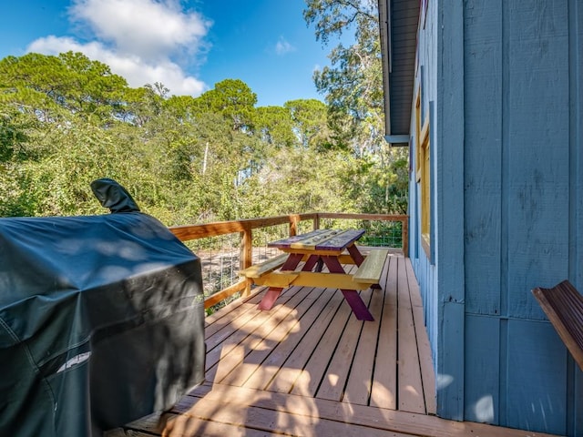 wooden terrace featuring grilling area