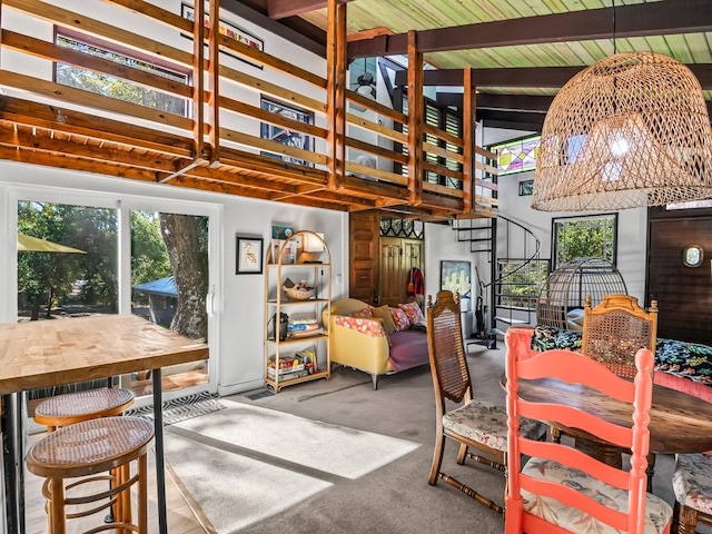 dining space featuring beamed ceiling