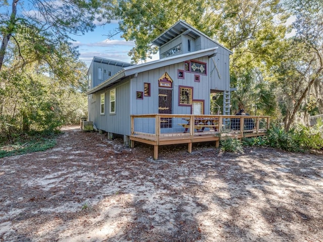 back of house featuring a wooden deck