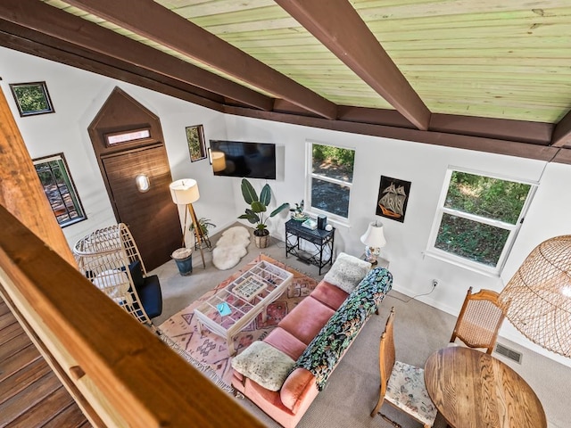 living room with beamed ceiling, wood ceiling, and hardwood / wood-style flooring