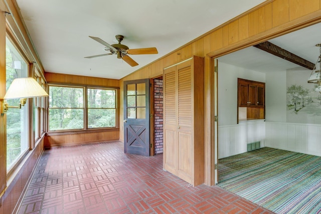 unfurnished sunroom featuring a wealth of natural light and ceiling fan