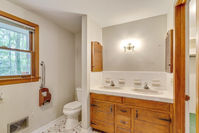 bathroom with vanity, toilet, and tile patterned flooring