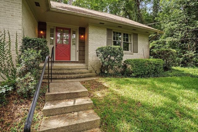 entrance to property with a lawn