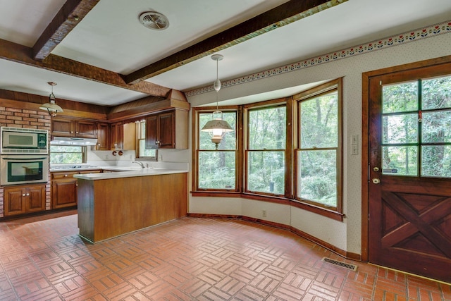 kitchen with stainless steel appliances, decorative light fixtures, beamed ceiling, and kitchen peninsula