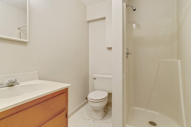 bathroom with vanity, a shower, and toilet