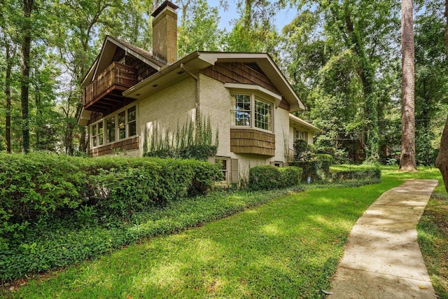 view of side of property with a lawn