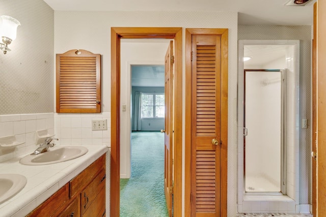 bathroom with an enclosed shower and vanity