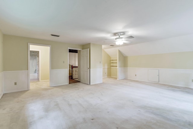 interior space with ceiling fan, lofted ceiling, and light carpet