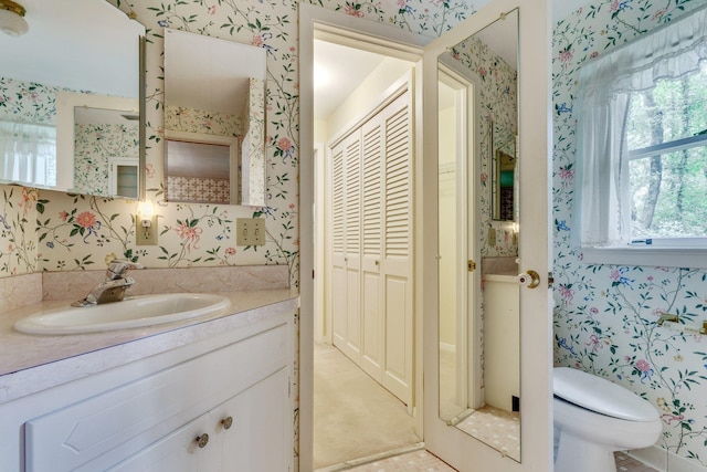 bathroom featuring vanity and toilet