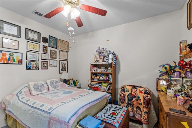 bedroom featuring a textured ceiling and ceiling fan