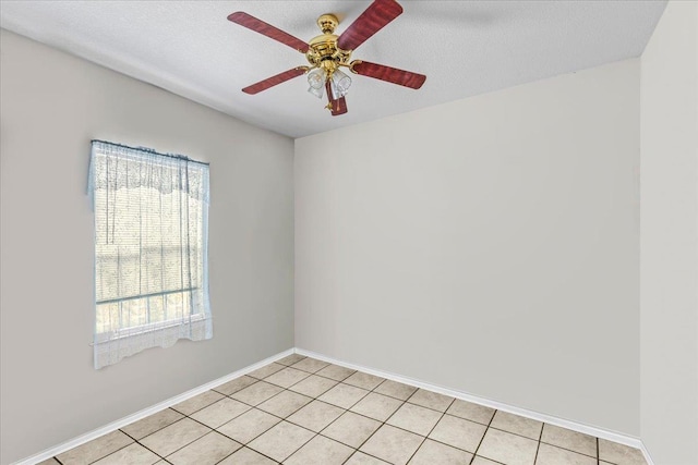 tiled empty room with a textured ceiling and ceiling fan