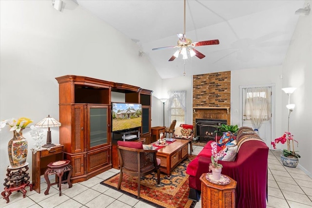 tiled living room featuring a large fireplace, ceiling fan, and high vaulted ceiling