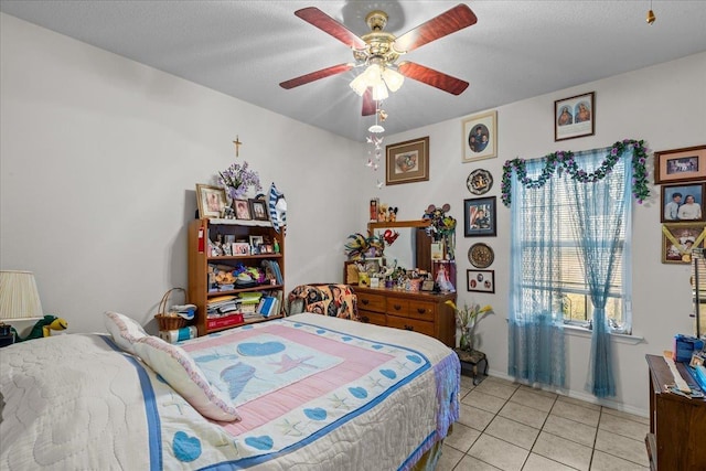 bedroom with ceiling fan and light tile patterned flooring