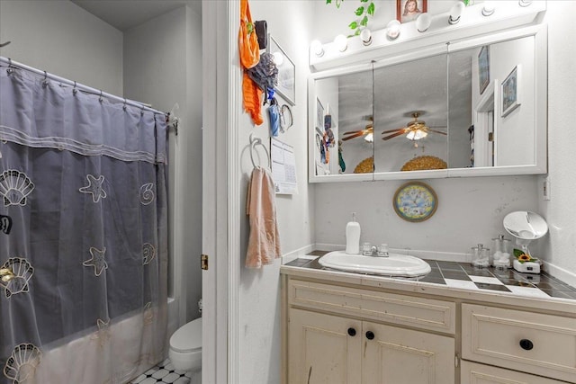 full bathroom featuring toilet, vanity, shower / bath combination with curtain, and ceiling fan