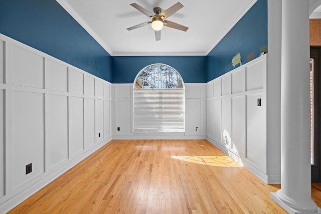 interior space with ceiling fan, crown molding, decorative columns, and light hardwood / wood-style floors