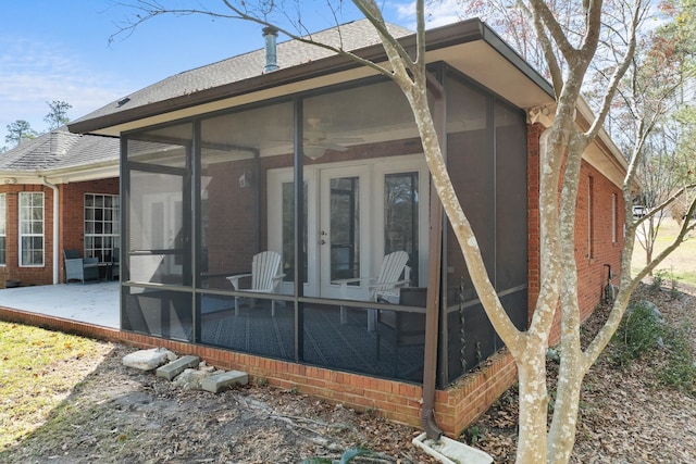 rear view of house featuring a patio and a sunroom