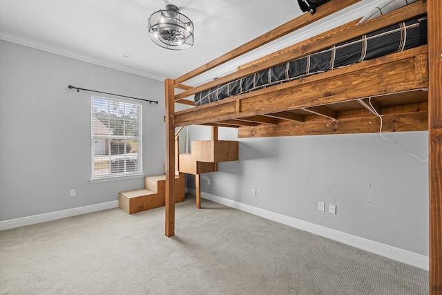 bedroom with ornamental molding and carpet flooring