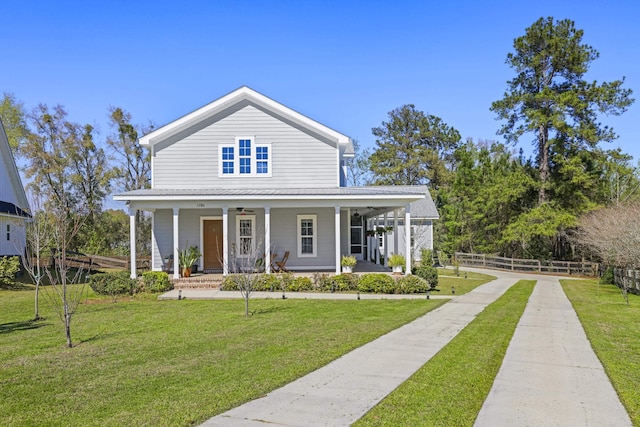 5286 Wild Goose Rd, Tallahassee, FL 32311 - country-style home featuring a front yard, fence, a porch, concrete driveway, and metal roof