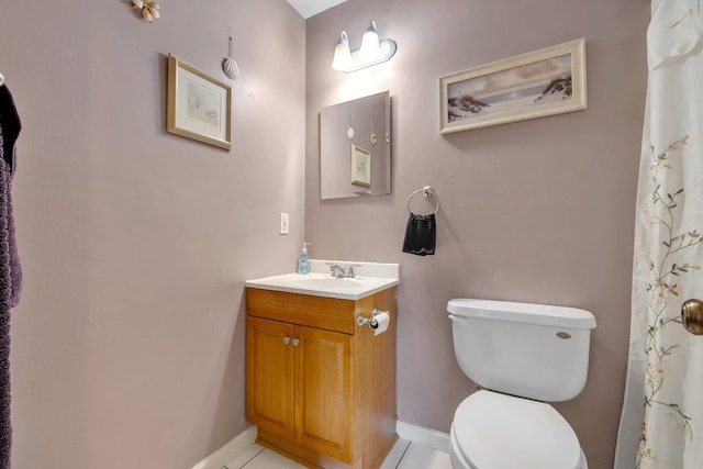 bathroom featuring toilet, vanity, and tile patterned flooring