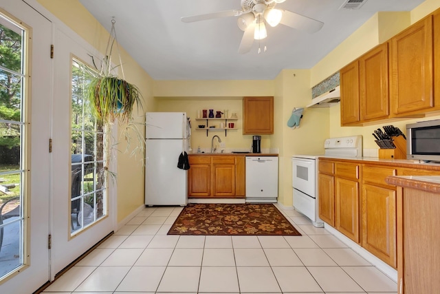 kitchen featuring light tile patterned floors, white appliances, ceiling fan, and sink