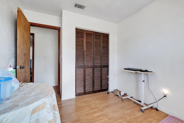 bedroom with a closet and light hardwood / wood-style flooring