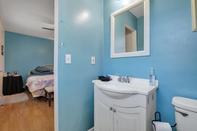 bathroom with vanity, hardwood / wood-style flooring, and toilet