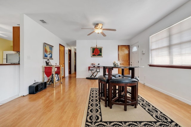 dining space with ceiling fan and light hardwood / wood-style floors