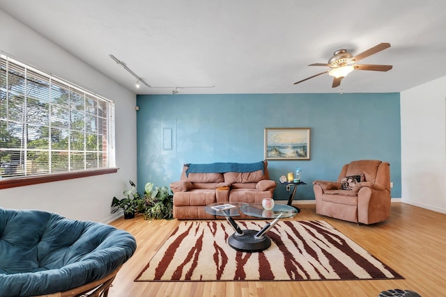 living room featuring wood-type flooring, ceiling fan, and rail lighting