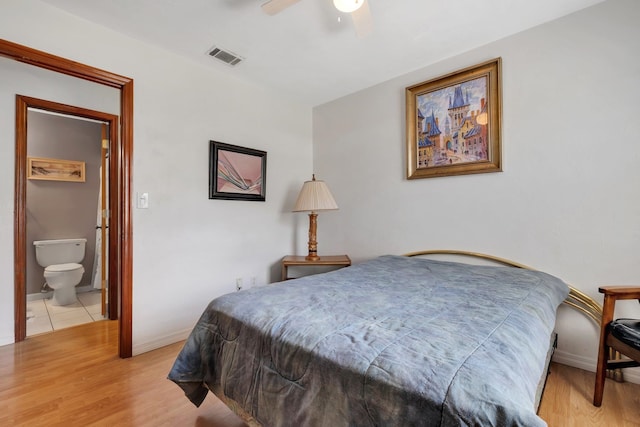 bedroom featuring ensuite bathroom, ceiling fan, and light hardwood / wood-style flooring