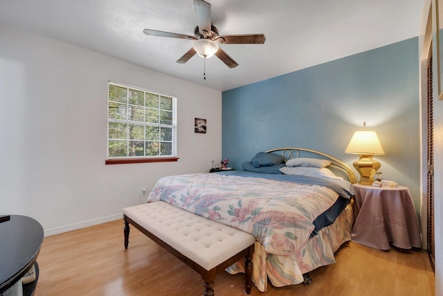 bedroom with light hardwood / wood-style flooring and ceiling fan