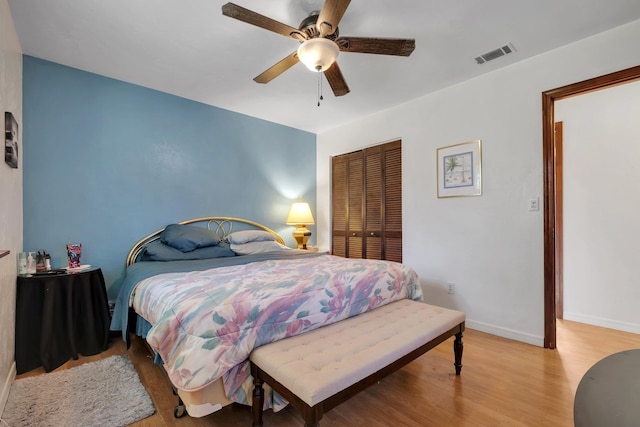 bedroom featuring a closet, light wood-type flooring, and ceiling fan