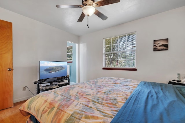 bedroom featuring hardwood / wood-style flooring and ceiling fan