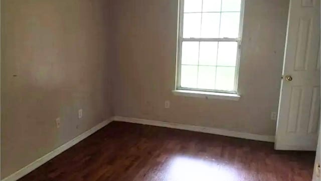 empty room with dark wood-type flooring