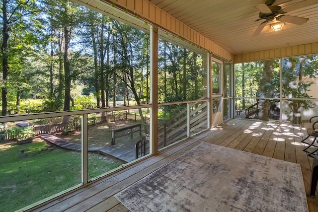 unfurnished sunroom with ceiling fan