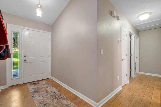entrance foyer with light wood finished floors and baseboards