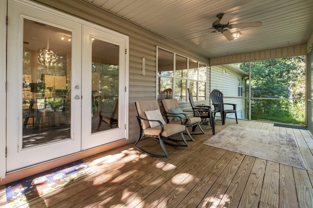wooden deck with french doors and a ceiling fan
