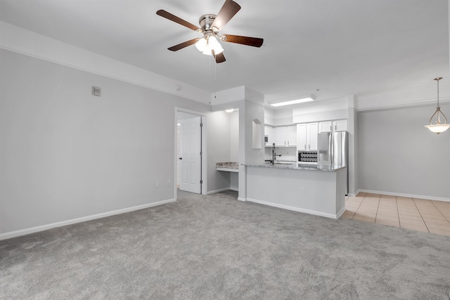2801 Chancellorsville Dr Unit 1218, Tallahassee, FL 32312 - unfurnished living room with light carpet, a ceiling fan, baseboards, and a sink