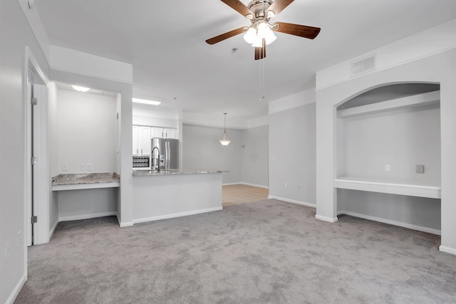 2801 Chancellorsville Dr Unit 1218, Tallahassee, FL 32312 - unfurnished living room with light colored carpet, ceiling fan, and baseboards