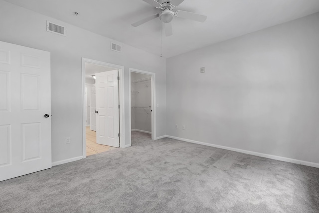2801 Chancellorsville Dr Unit 1218, Tallahassee, FL 32312 - unfurnished bedroom featuring carpet, a walk in closet, baseboards, a closet, and ceiling fan