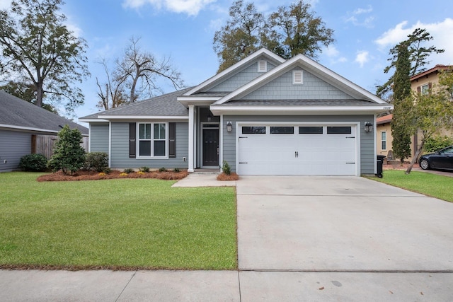 view of front of home featuring an attached garage, a shingled roof, concrete driveway, and a front yard