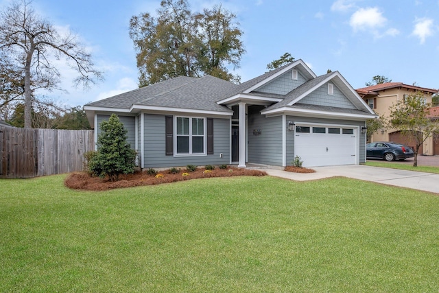 view of front of home featuring a shingled roof, a front yard, fence, and driveway