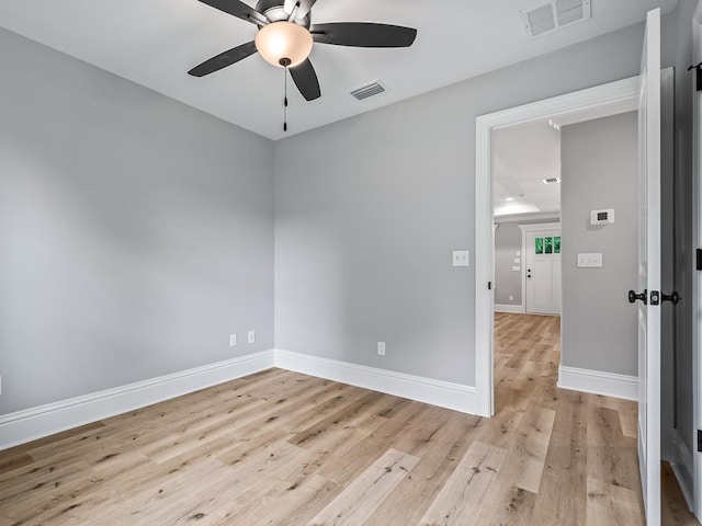 empty room with ceiling fan and light wood-type flooring